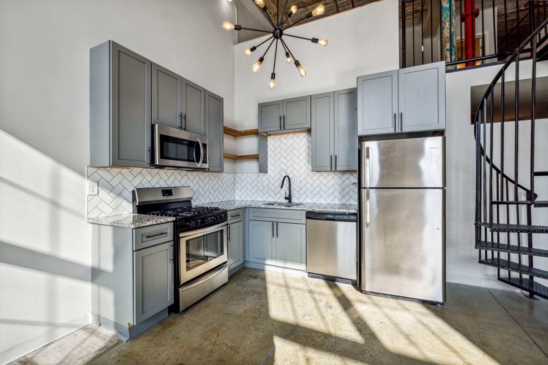 Empty room with wood floors, ceiling fan, and sliding glass door leading to a patio with vertical blinds at Apex West Midown.